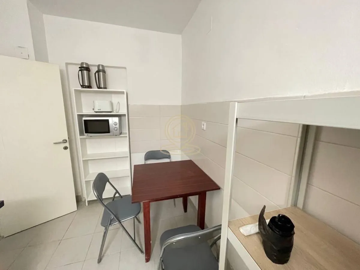 Small kitchen with a dining table and chairs.