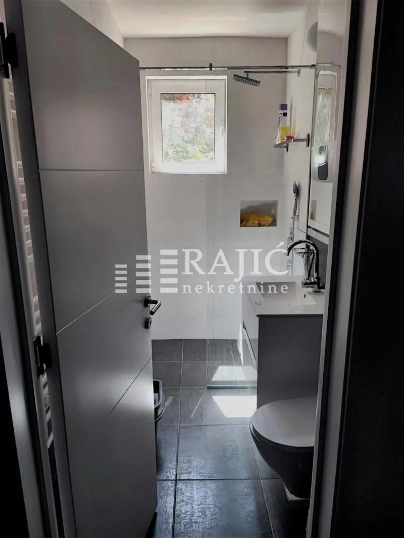 View of a modern bathroom with a walk-in shower.