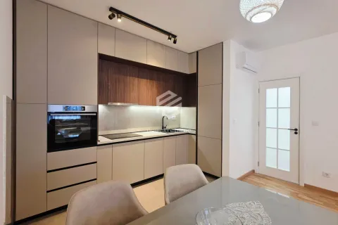 Modern kitchen with built-in units and a dining table. - image 12