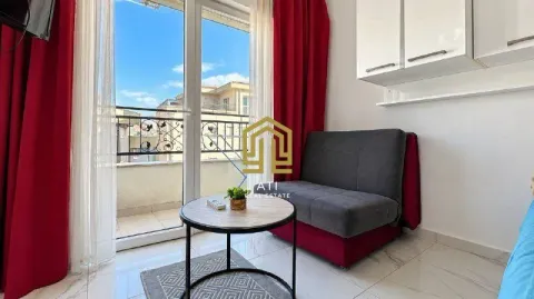 Smaller living room with a sofa, coffee table, and access to the terrace. - image 3
