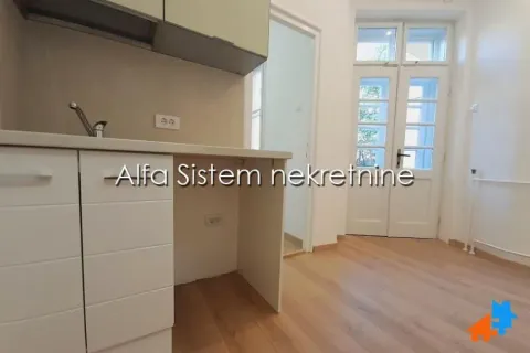 Small kitchen with white units and a view of the door. - image 7