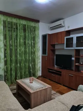 Living room with wooden furniture and a TV. - image 3
