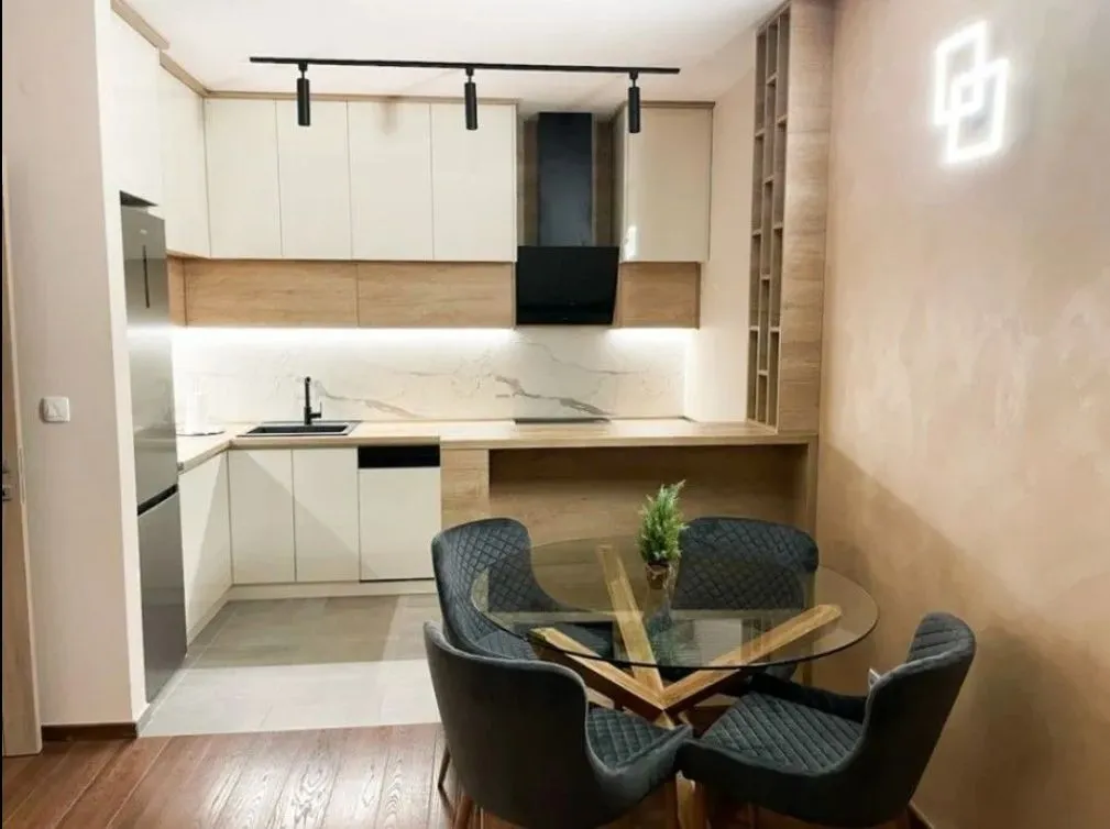 Modern kitchen with built-in cabinetry and a dining table with chairs.