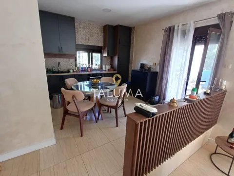 Kitchen with dining area and dark cabinets. - image 6