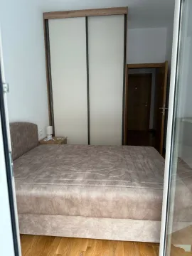 Furnished bedroom with a double bed and built-in wardrobe. - image 10