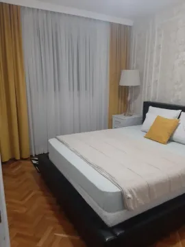 Furnished bedroom with a double bed, nightstand, and lamp. - image 4