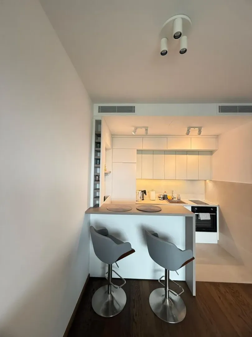 Modern kitchen with a breakfast bar and bar stools.