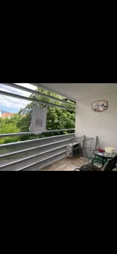 Unfurnished terrace with a clothes drying rack and a table. - image 5