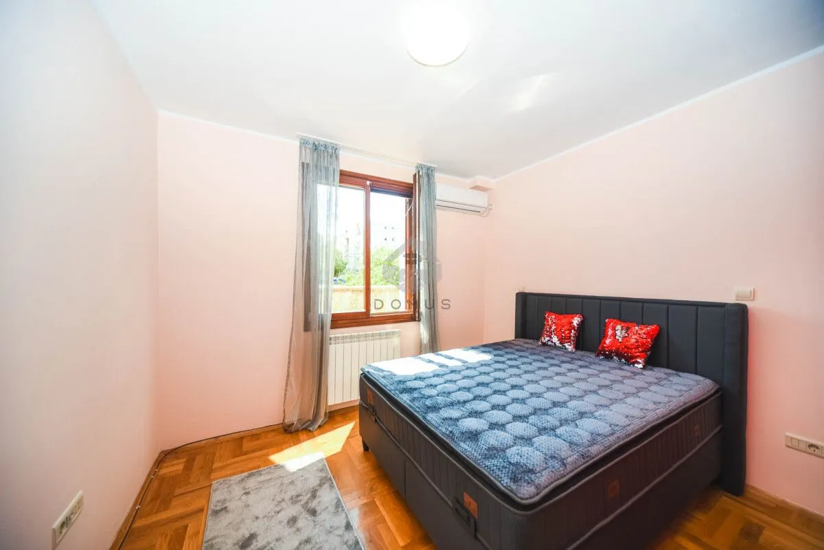 Bedroom with a double bed and a window.