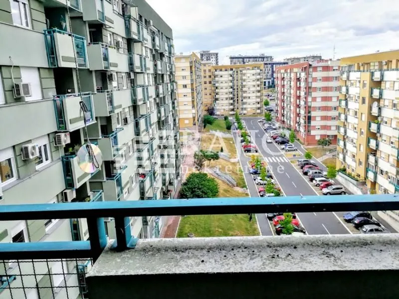 View from the balcony overlooking residential buildings and the neighborhood.
