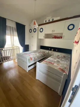 Children's bedroom with two beds and a crib. - image 8