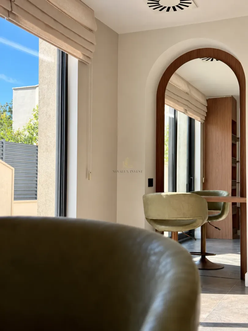 View of the living room interior with a dining table and chairs.