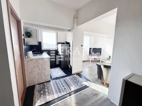 View from the hallway towards the kitchen and living room in the apartment. - image 8