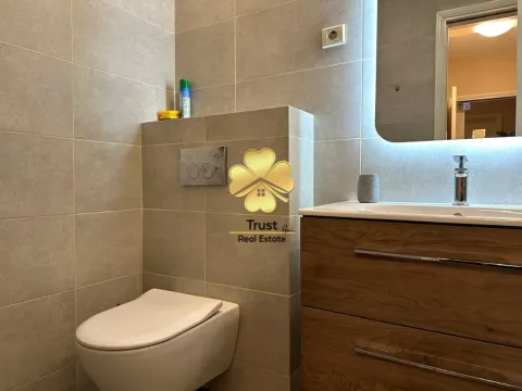 Modernly equipped bathroom with a vanity and a toilet. - image 10