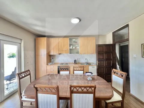 Kitchen with a dining area and wooden furniture. - image 3