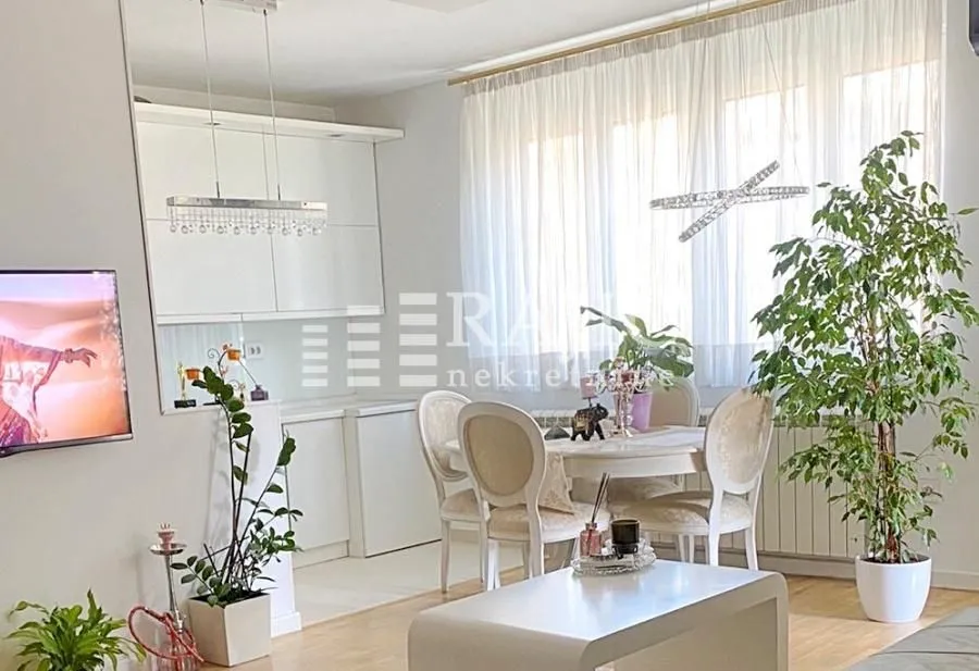 Living room with dining area and seating furniture.