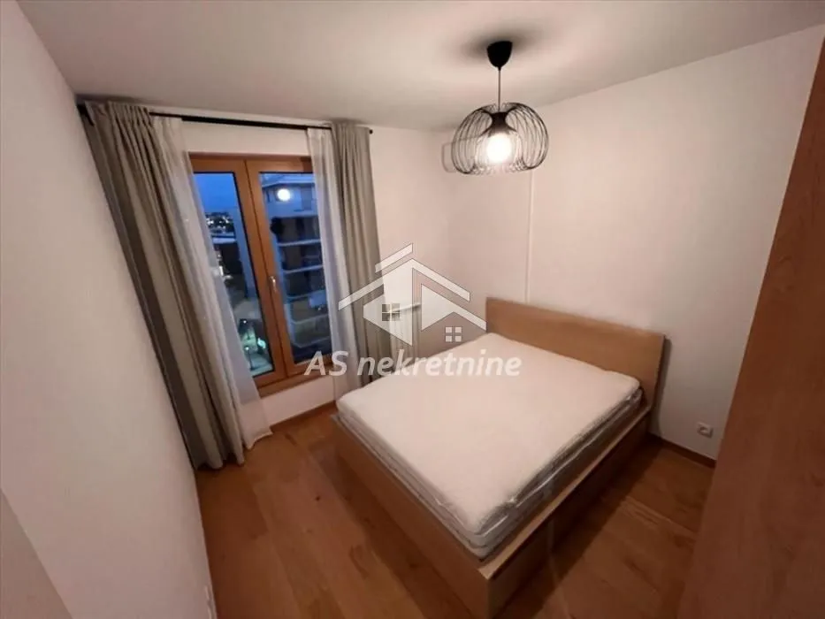 Bedroom with a double bed and a window overlooking the surroundings.
