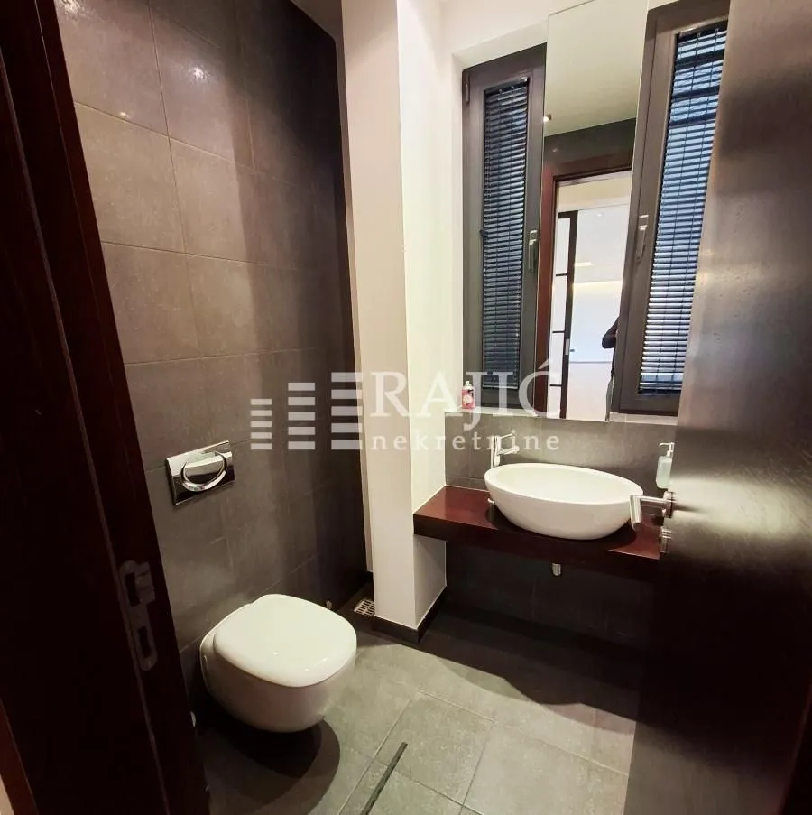 Modern bathroom with a sink and toilet bowl.