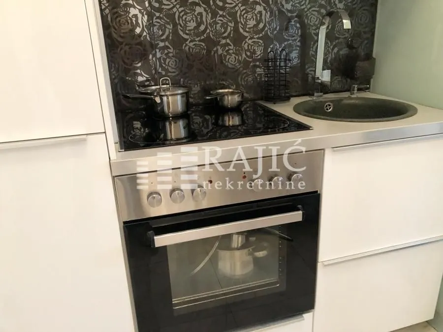 Modern kitchen with built-in stovetop, oven, and sink.