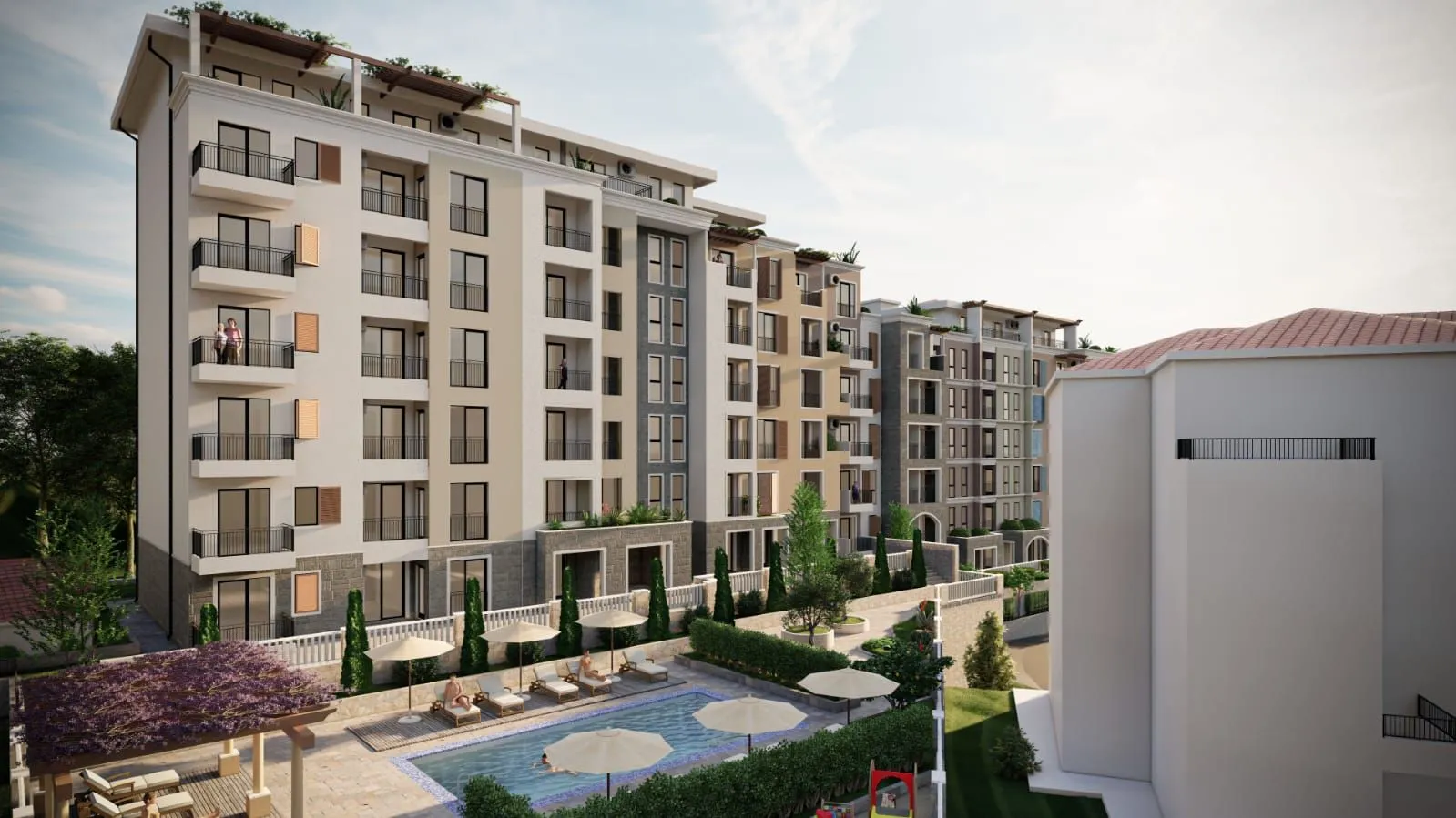 Exterior view of a modern residential complex with a swimming pool.