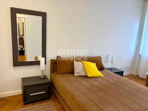 Bedroom with a double bed, bedside tables, and a wall mirror. - image 15