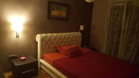 A bedroom featuring a double bed and warm ambient lighting. - image 5