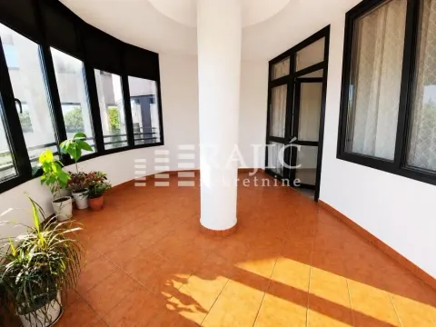 Spacious enclosed terrace with ceramic tile flooring and a central column. - image 4
