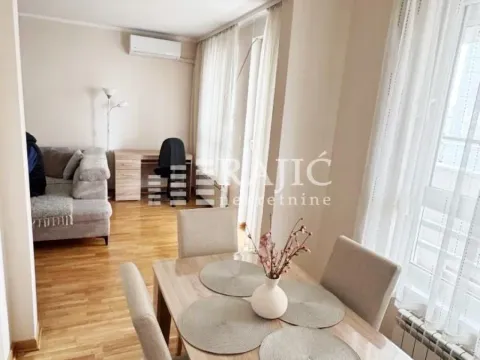 Living room with a dining area and a workspace. - image 3