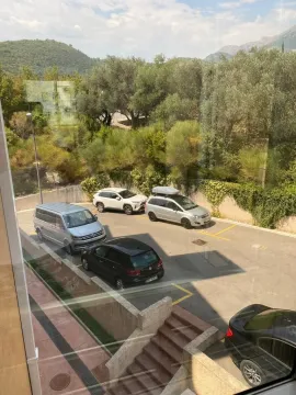View from the window of the parking area and surrounding greenery. - image 12