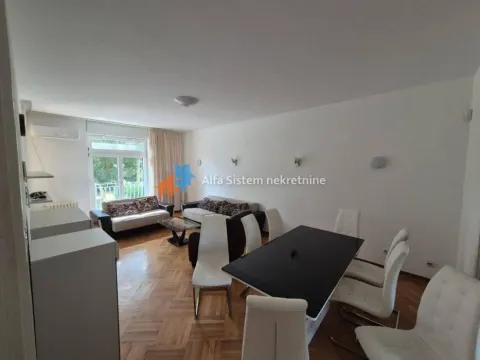 Spacious living room with dining area and parquet flooring. - image 6
