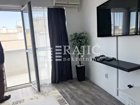 Living room with access to the terrace and a wall-mounted TV. - image 9