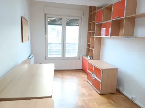 Children's room with a desk and orange furniture units. - image 5