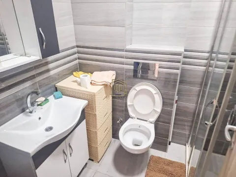 Bathroom equipped with a washbasin, toilet bowl, and walk-in shower. - image 7