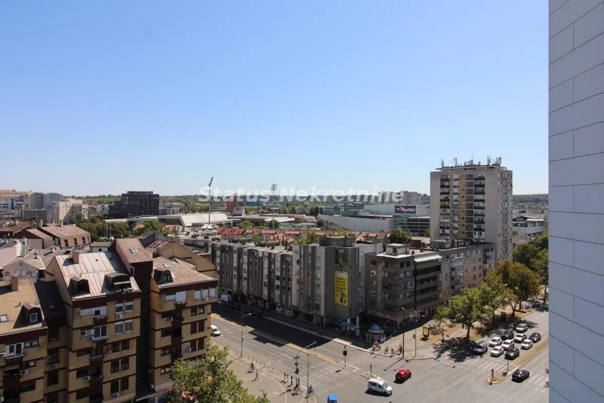 View from the window overlooking the city street and surrounding buildings.