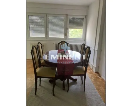 Dining table with chairs in front of the windows. - image 2