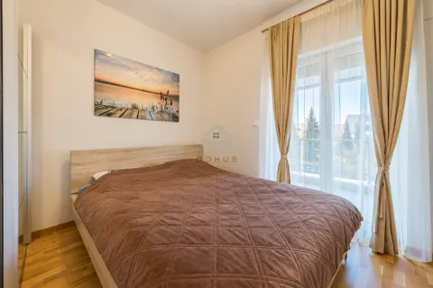 Bedroom with a double bed, wooden floor and access to the terrace. - image 15