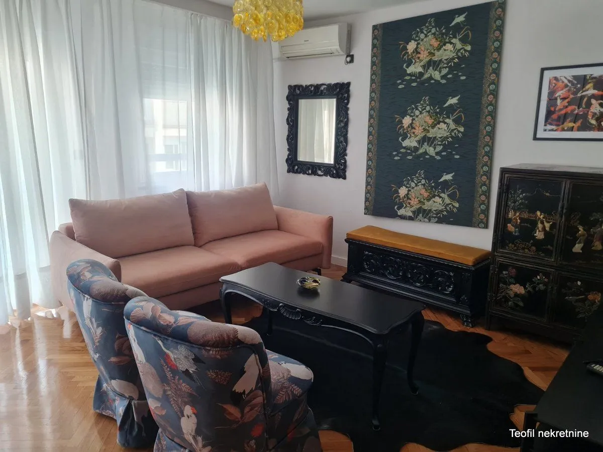 Living room with a sofa, armchairs, and a coffee table.