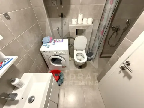 Smaller bathroom with a washing machine, sink and shower cabin. - image 3
