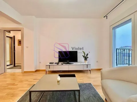 Living room with a TV, coffee table, and access to the terrace. - image 8