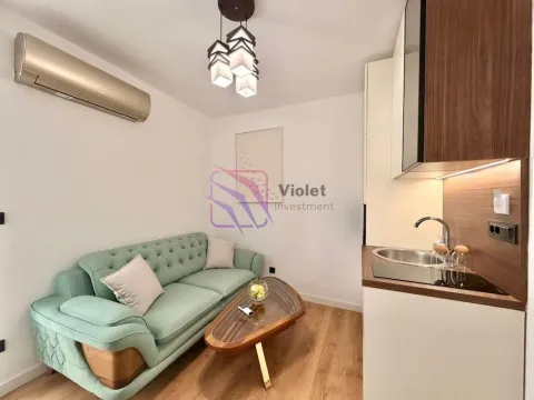 Living room with a sofa and open-plan kitchen. - image 14