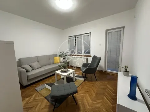 Living room furnished with a sofa, coffee table, and hardwood flooring. - image 8