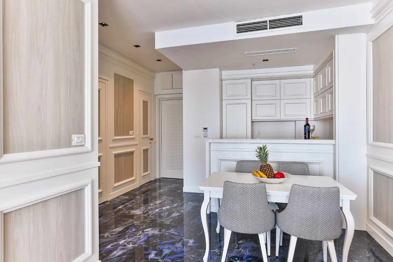 Modern kitchen with dining area and elegant interior.