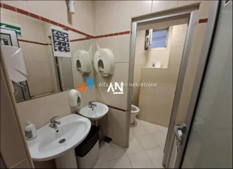 View of a tiled bathroom with washbasins and a mirror. - image 13