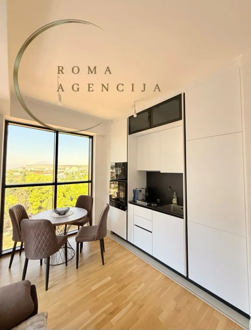 Modern kitchen with a dining area and a large window.