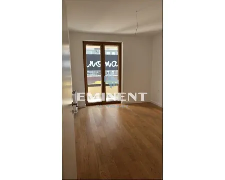 Empty room with hardwood floors and balcony doors. - image 6