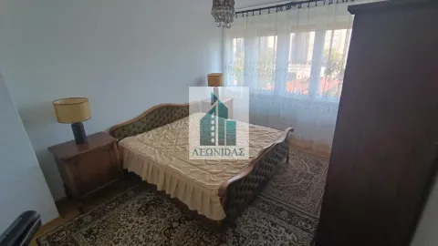 Furnished bedroom with a double bed, bedside tables, and a window with curtains. - image 13