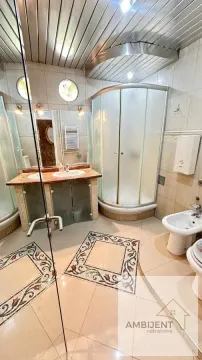 Bathroom equipped with a shower cabin, washbasin, and sanitary fixtures. - image 7