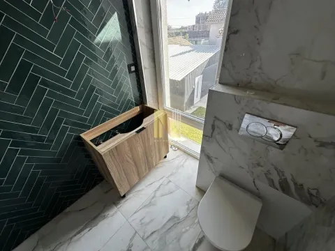 Newly renovated bathroom with plumbing fixtures and green tiles. - image 18