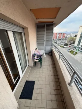 Furnished balcony with seating set and street view. - image 7