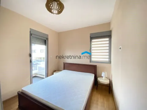 Furnished bedroom with a double bed and balcony access. - image 5